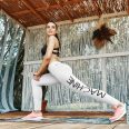 Womens white yoga leggings with motivational word machine on left leg